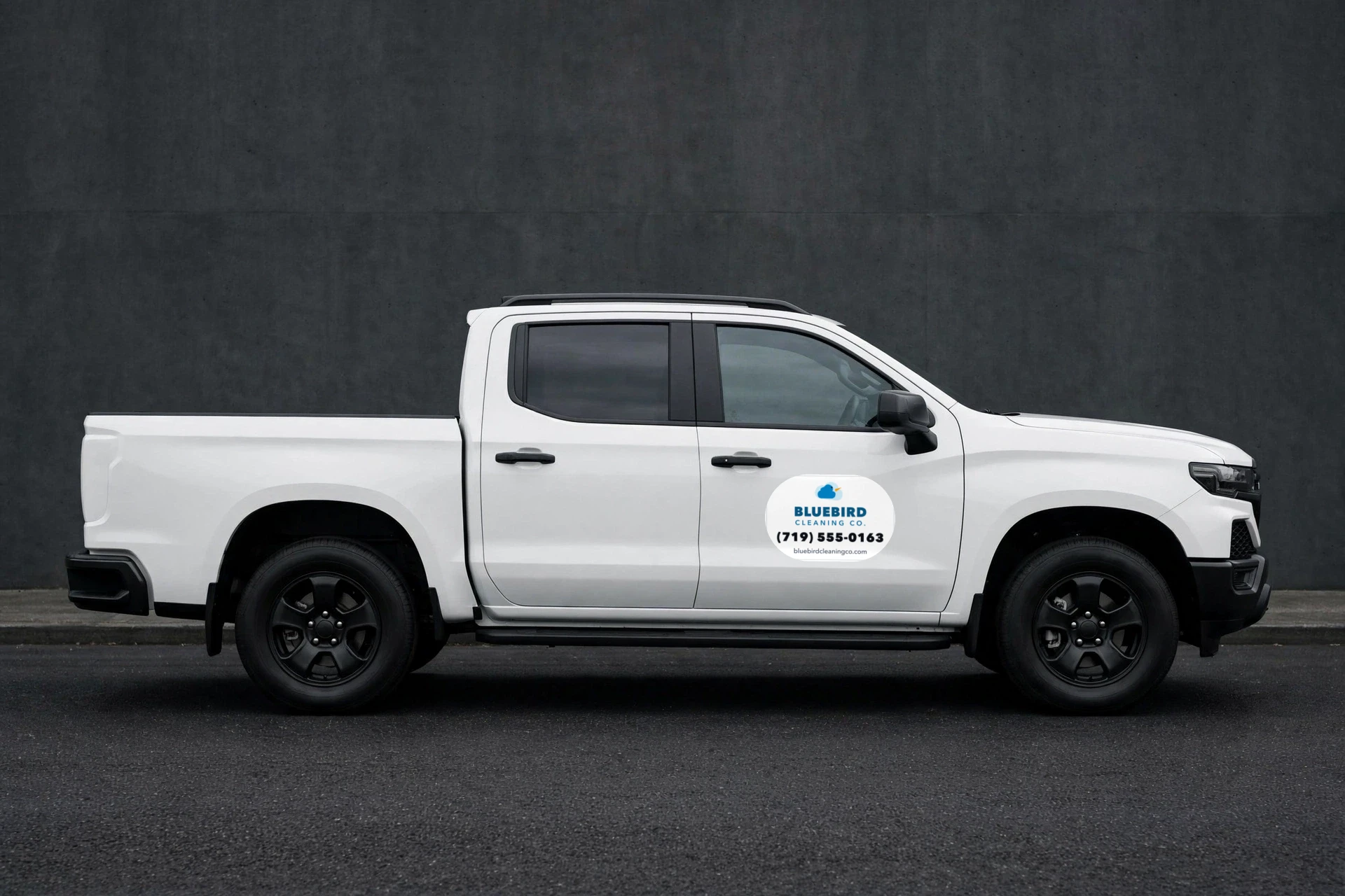 Rounded-corner magnet sign for a fictional cleaning company on a white truck door