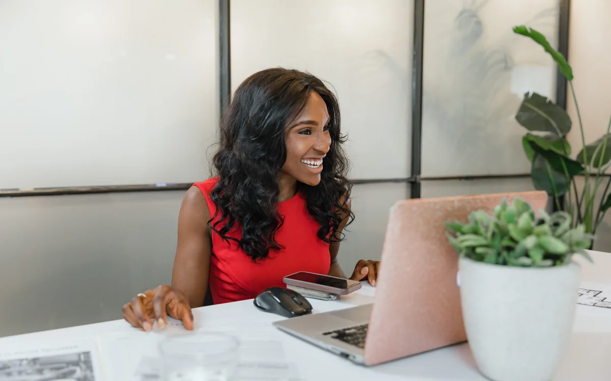 A business owner working at a laptop in her own shop