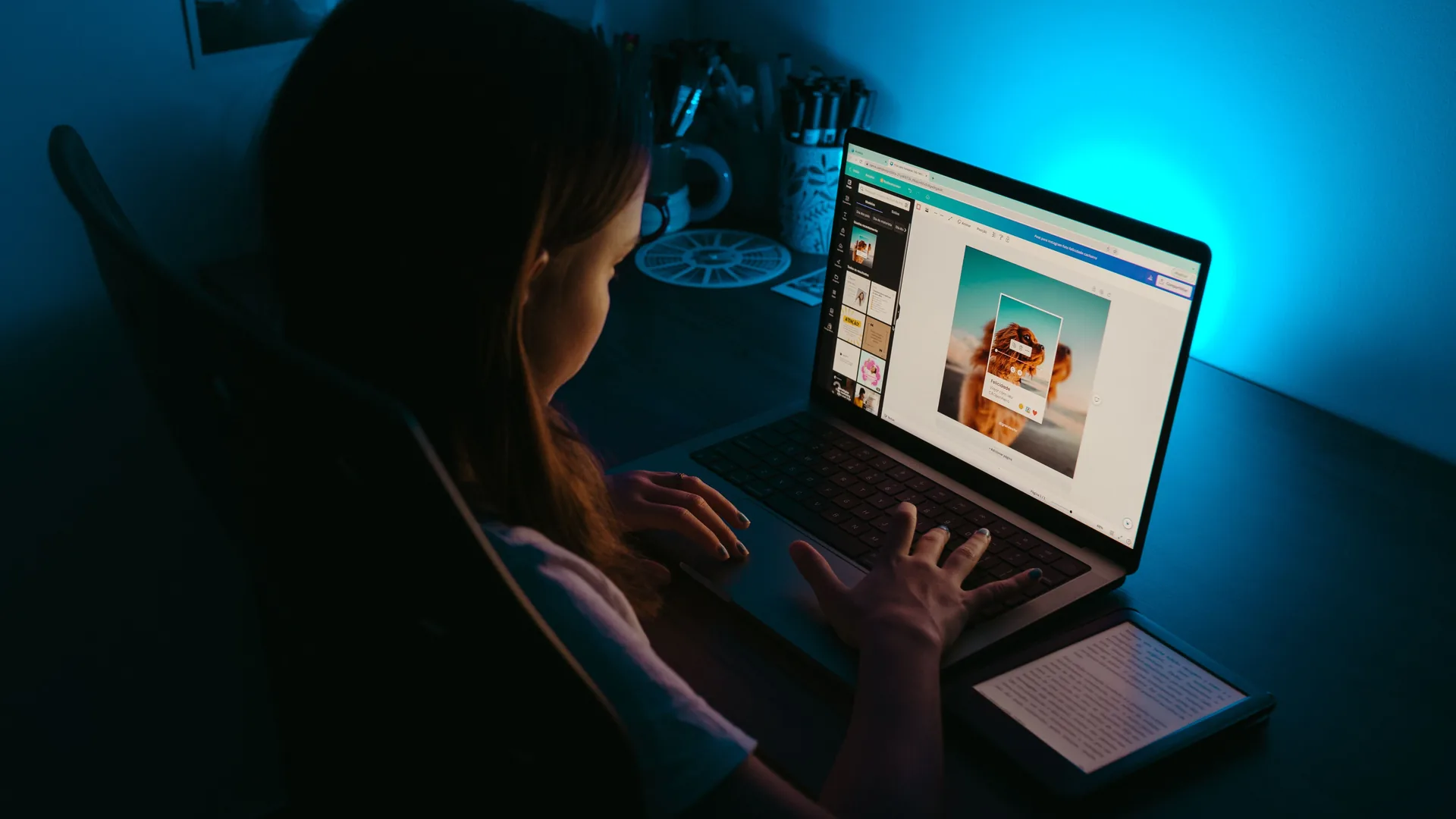 A designer working on a layout in the editor, seen over the shoulder